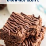 Two fudgy brownies with chocolate drizzle stacked, one with a bite missing. Text reads: Vintage Betty Crocker Brownies Recipe.