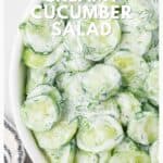 Sliced cucumbers in creamy dressing with dill, served in a white bowl. Text reads: Creamy Cucumber Salad.