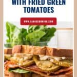 A BLT sandwich with fried green tomatoes, lettuce, and mayonnaise on toasted bread, with a leafy background.