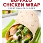 A grilled buffalo chicken wrap with lettuce and ranch, served with celery sticks on a white plate.