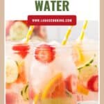 Mason jars of infused water with strawberries, cucumber, and lemon slices, each with a yellow striped straw.