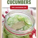 A jar of quick pickled cucumbers with dill and a bay leaf, labeled Quick Pickled Cucumbers.