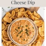 A bowl of Velveeta sausage cheese dip surrounded by tortilla scoops on a wooden board.
