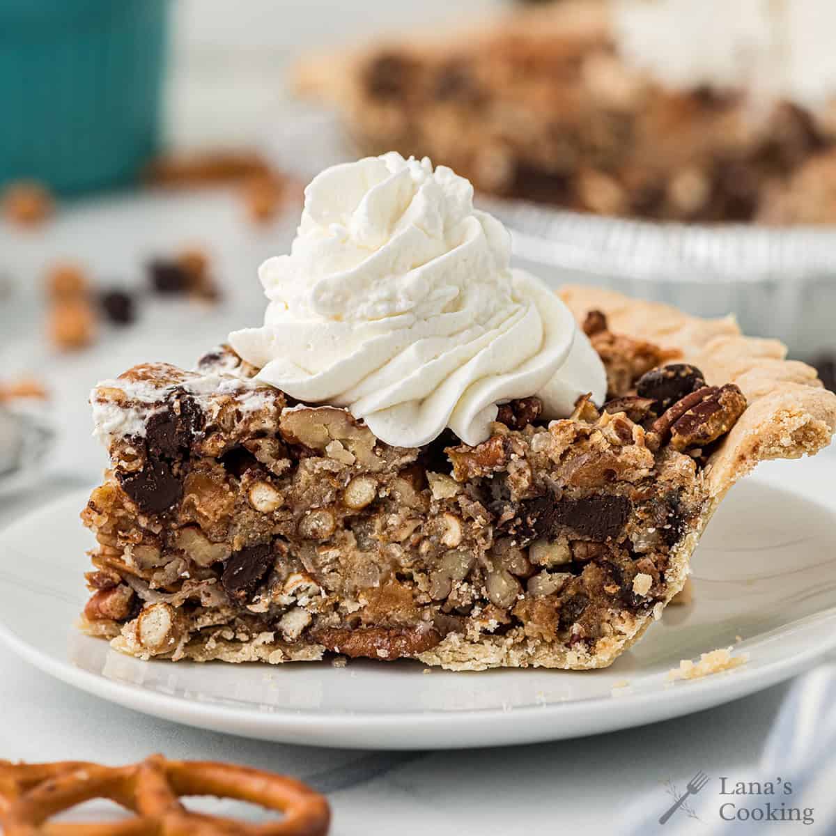 A slice of Texas trash pie topped with whipped cream.
