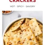 A bowl of square crackers coated with spicy seasoning, labeled Alabama Fire Crackers: Hot - Spicy - Savory.