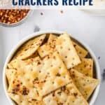 Bowl of seasoned saltine crackers with red pepper flakes, text reads Alabama Fire Crackers Recipe.