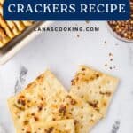 Square crackers with red pepper flakes on a white surface, labeled Alabama Fire Crackers Recipe.