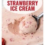 A scoop of homemade strawberry ice cream with visible strawberry pieces, and a spoon on top.