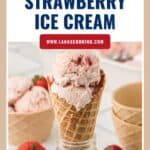 Waffle cone with strawberry ice cream, fresh strawberries, ice cream scoops, and bowls in the background.