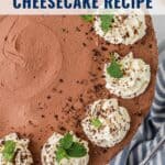 Top view of a no-bake chocolate cheesecake with whipped cream, chocolate shavings, and mint leaves.