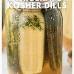 A jar of homemade kosher dill pickles with dill sprigs, labeled as a Claussen copycat refrigerator recipe.