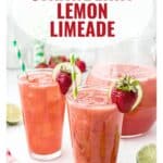 Two glasses of strawberry lemon limeade with straws, garnished with strawberries, next to a pitcher and lime slices.
