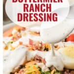 A spoon pouring buttermilk ranch dressing over a salad with bacon, eggs, and cheese.
