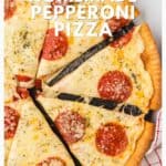 A homemade pepperoni pizza cut into slices on a white surface with text promoting the recipe.