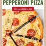 A sliced homemade pepperoni pizza with melted cheese and herbs on a light background.