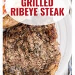 Grilled ribeye steak on a white plate with text overlay reading Perfect Grilled Ribeye Steak.
