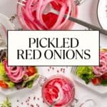 Two glass jars filled with pickled red onions sit on a white surface. A fork rests in each jar. Plates of salad, pink peppercorns, and greens surround the jars. Text reads “PICKLED RED ONIONS.”.