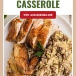 A plate with roasted chicken slices and sausage rice casserole, garnished with a sprig of parsley.