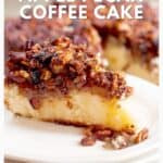 A slice of apple pecan coffee cake on a white plate, topped with a layer of chopped pecans.
