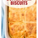 Golden butter swim biscuits in a white baking dish, with text overlay and website www.lanascooking.com.