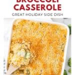 A baked cheesy broccoli casserole with a breadcrumb topping, served in a white dish with a wooden spoon.