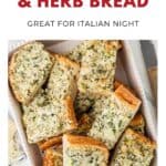 Sliced cheesy onion and herb bread on a tray, garnished with herbs, ready to serve.