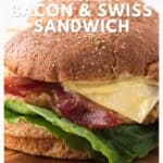 Close-up of a chicken, bacon, Swiss cheese sandwich with lettuce on a whole wheat bun.