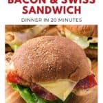 A chicken, bacon, and Swiss cheese sandwich with lettuce on a whole wheat bun.