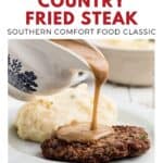 Gravy is poured over country fried steak with mashed potatoes on a plate, text reads Southern Country Fried Steak..