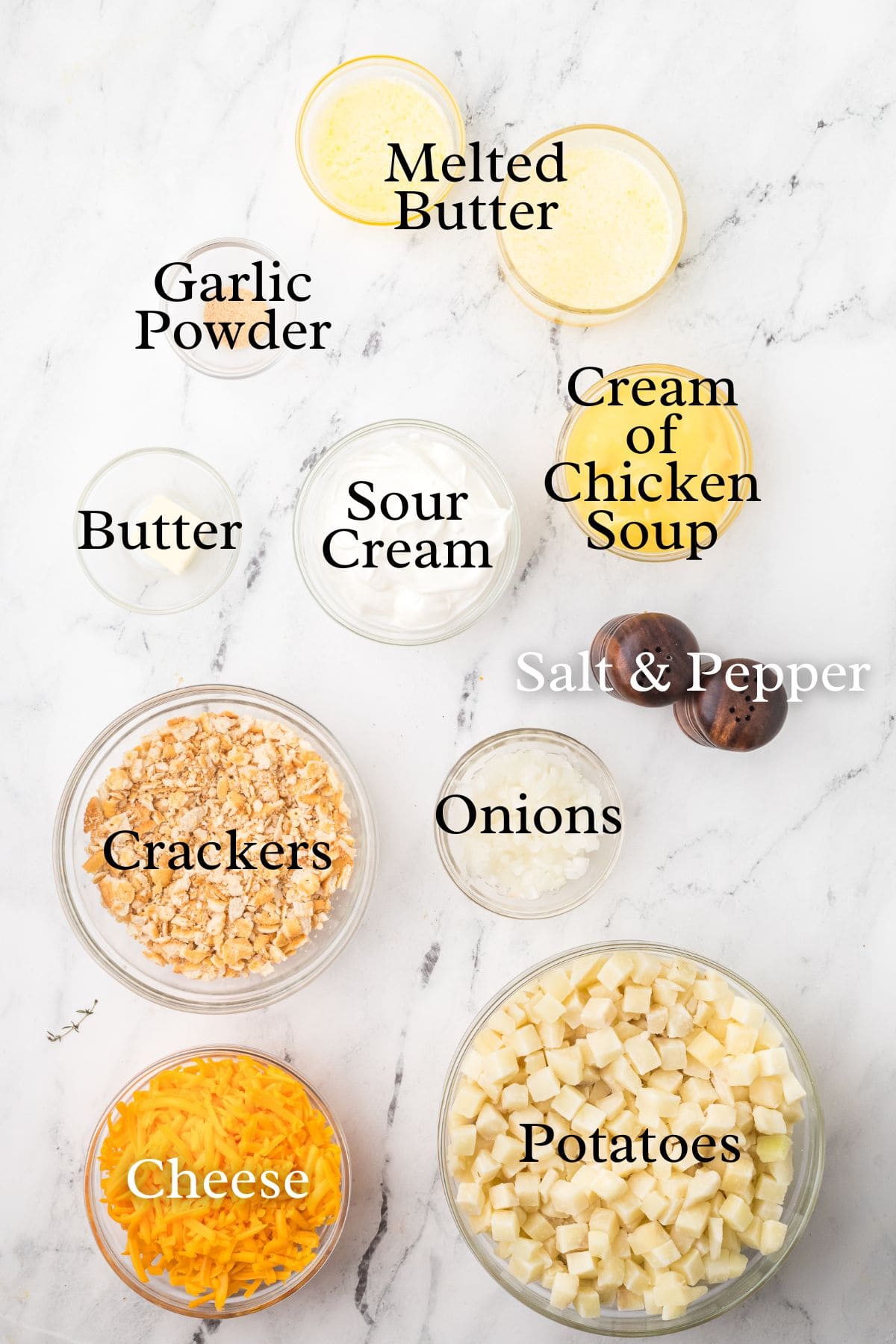 Ingredients for a casserole shown: potatoes, cheese, crackers, onions, seasonings, butter, sour cream, soup.