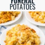 A serving of cheesy funeral potatoes on a white plate with a casserole dish in the background.