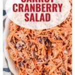 Bowl of carrot cranberry salad with creamy dressing, viewed from above, text overlay reads Carrot Cranberry Salad.