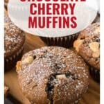 Chocolate cherry muffins on a wooden tray, dusted with powdered sugar, with text overlay and website link.