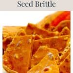 Pieces of cinnamon pumpkin seed brittle in a bowl, with the text Cinnamon Pumpkin Seed Brittle above.