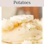 A bowl of mashed potatoes topped with a pat of butter and herbs, with text reading Everyones Favorite! Easy Mashed Potatoes.