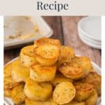 A pile of golden-brown roasted melting potatoes on a white plate.