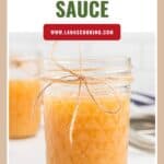 A jar of Jezebel sauce with a twine bow, labeled with the recipe website lanascooking.com.