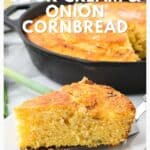 A slice of golden sour cream and onion cornbread on a plate with the rest in a skillet behind.