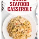 A plate of baked seafood casserole with a fork, text overlay reads Baked Seafood Casserole.