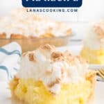 A slice of coconut meringue pie on a plate with the whole pie in the background.