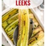 A serving spoon holding a roasted leek over a tray of roasted leeks; text reads Roasted Leeks.