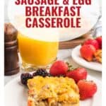 A plate with sausage and egg casserole, fresh berries, and juice, with text: Sausage & Egg Breakfast Casserole.