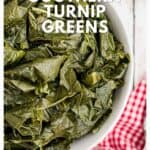 A bowl of cooked turnip greens on a table with a red checkered cloth, text overlay reads Southern Turnip Greens..