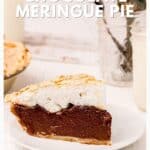 A slice of chocolate meringue pie on a white plate, with a pie and milk jar in the background.