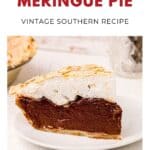 Slice of chocolate meringue pie on a white plate, topped with fluffy golden meringue.