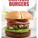 A meatloaf burger with lettuce, tomato, and onions on a bun, with text MEATLOAF BURGERS.