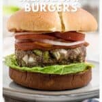 A meatloaf burger with lettuce, tomato, and onion on a bun sits on a plate with text overlay promoting the recipe.