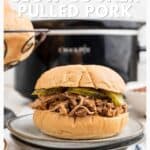 Pulled pork sandwich with pickles on a plate in front of a slow cooker, with text about slow cooker pulled pork.
