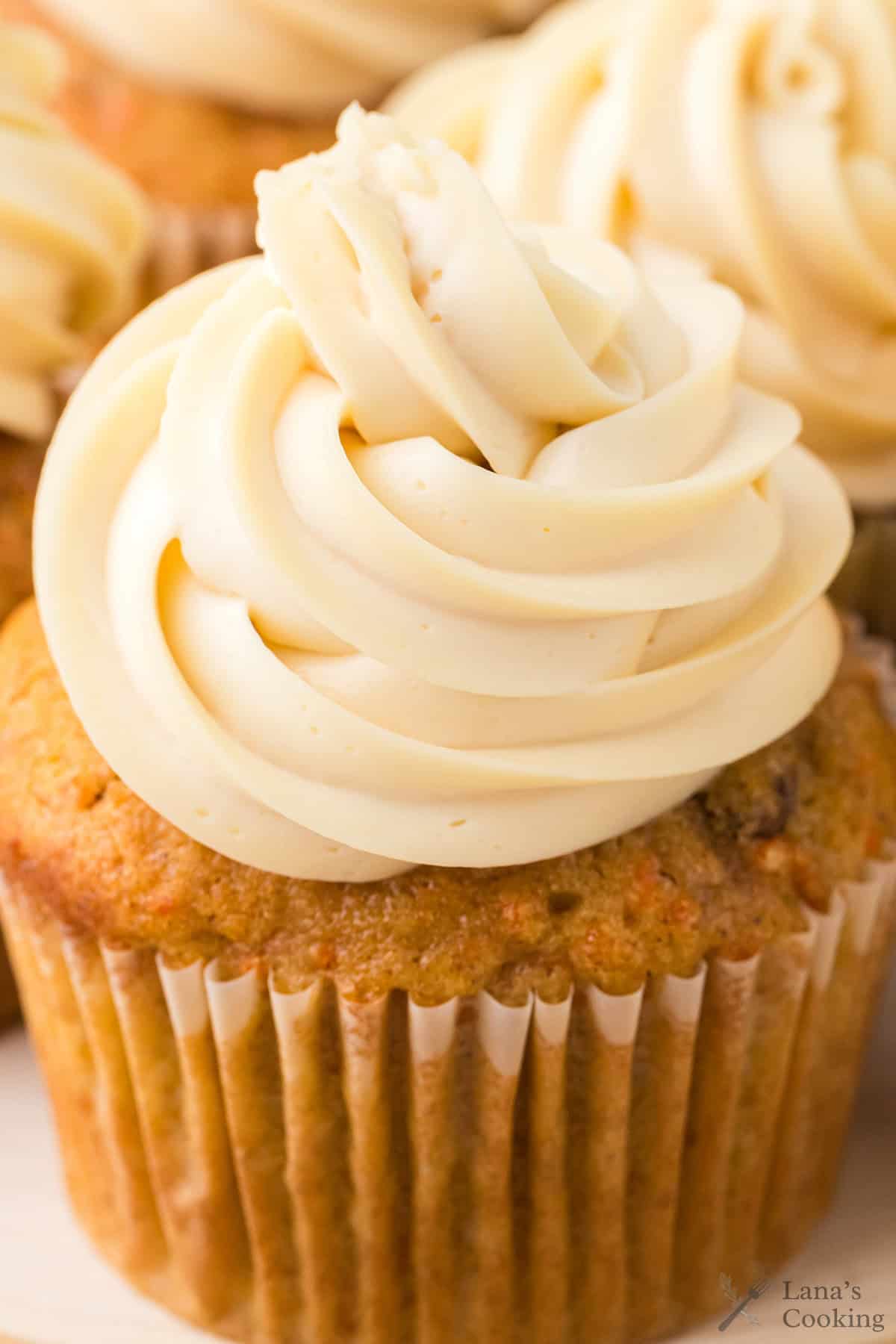 Close-up of a cupcake with swirled frosting on top.