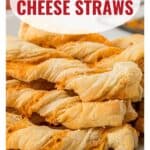 Golden, twisted puff pastry cheese straws stacked on a plate, with a recipe website link below.